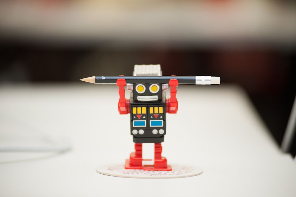 thoughtbot robot holding a pencil